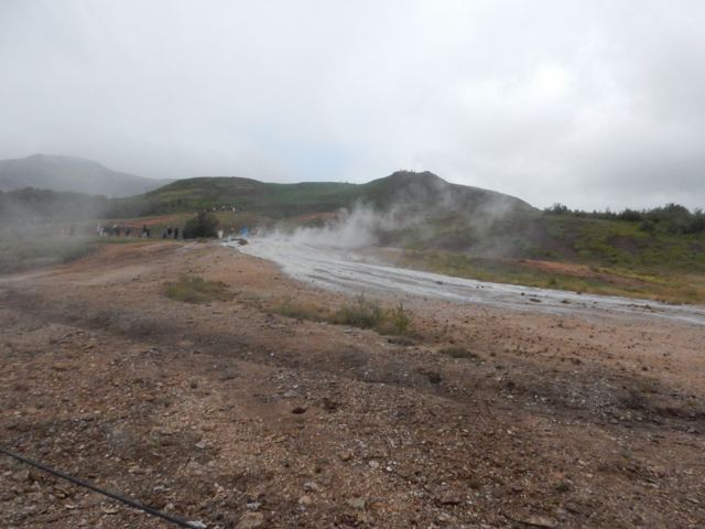 Steam drifting over a barren hillside