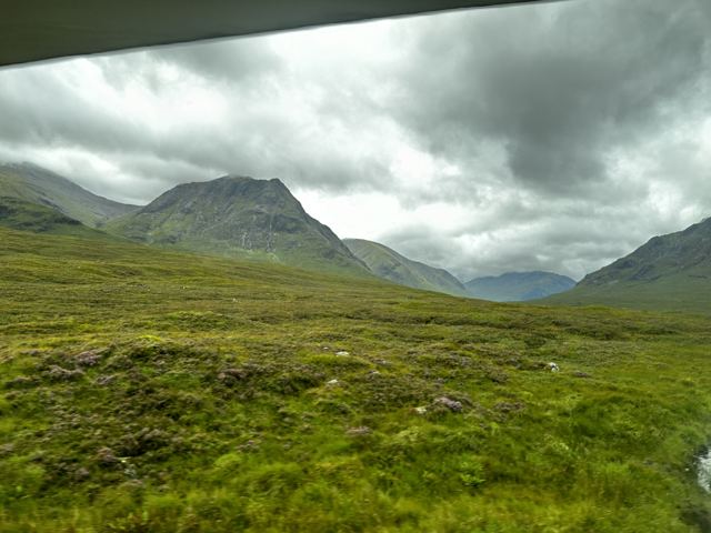 A green glen below rain clouds