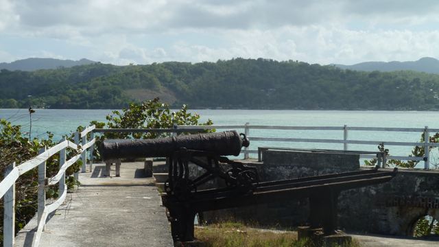 An old cannon on a hilltop overlooking a harbour