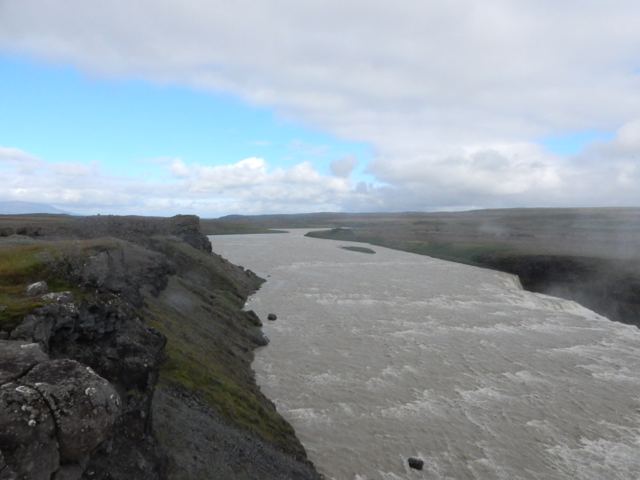 A broad river between rocky banks