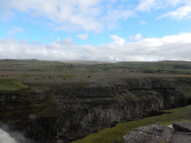 Canyon walls above a misty river