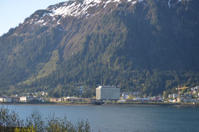 A mountain rising above a harbour town