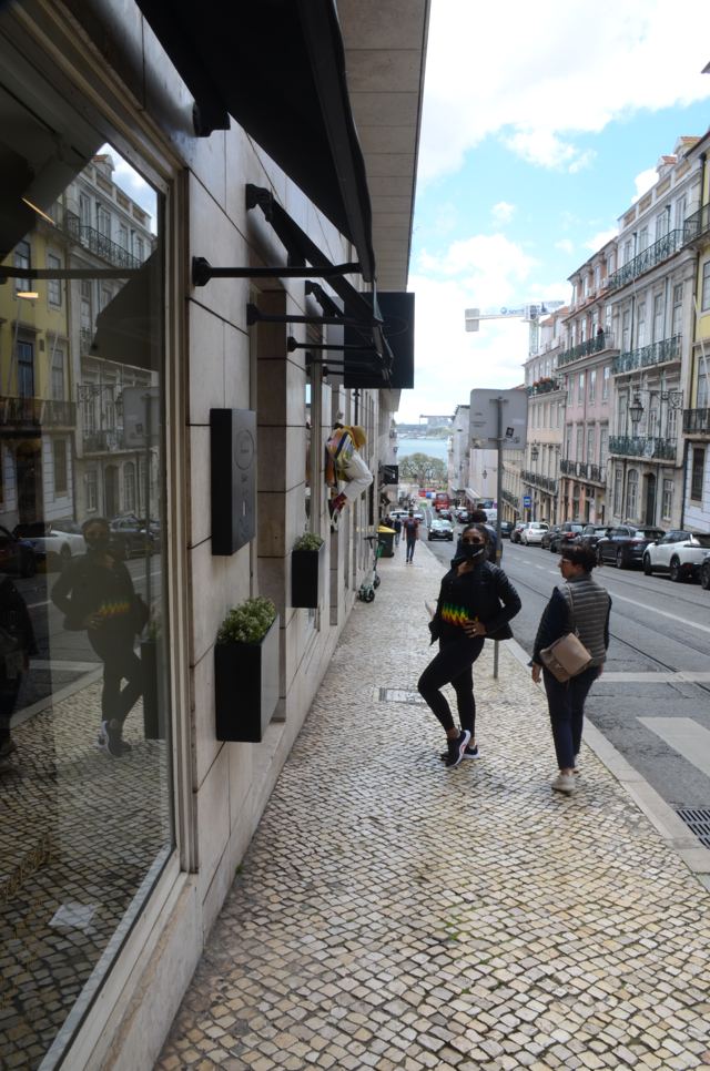 A cobbled street between tall buildings