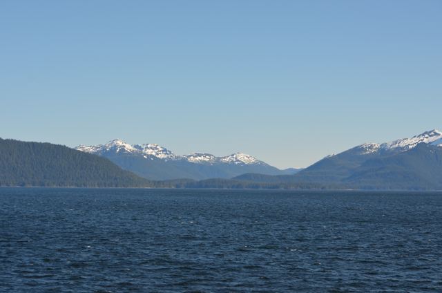 Snow-capped mountains across calm water