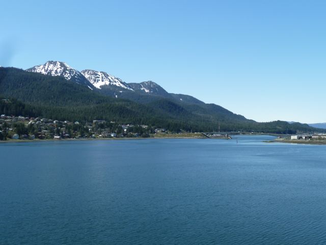 Blue water and mountains beside a coastal town