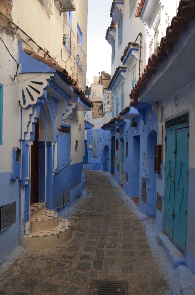 A winding lane of blue and white buildings