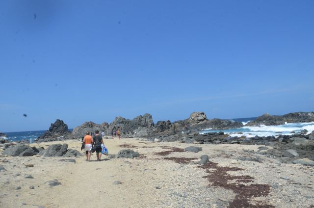 A rocky beach under blue sky
