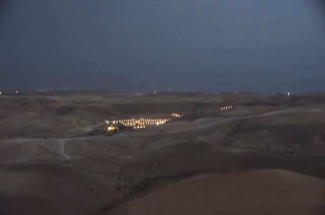 Lights of a desert camp at dusk