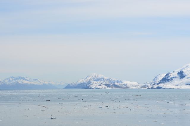 An ice-flecked bay below white mountains
