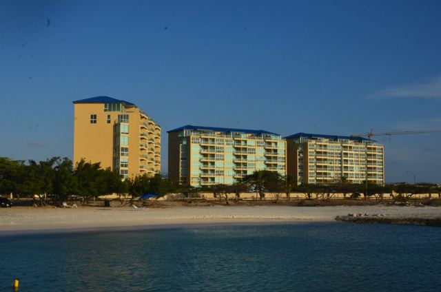 Resort towers behind a sandy beach