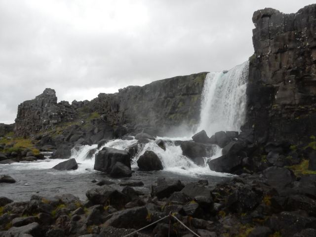 A waterfall tumbling over dark rocks