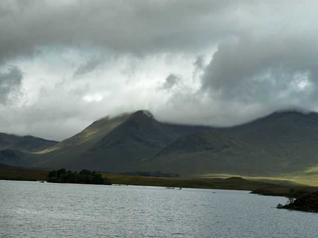 Dark mountains above a loch under heavy cloud