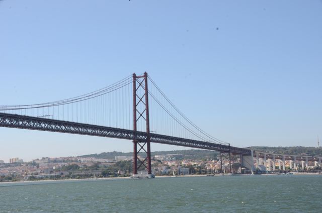A red suspension bridge over the river