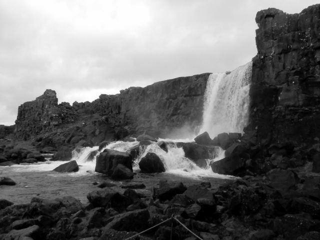A waterfall tumbling over dark rocks