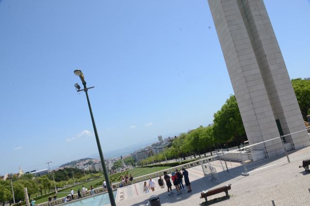 A tall monument above a plaza
