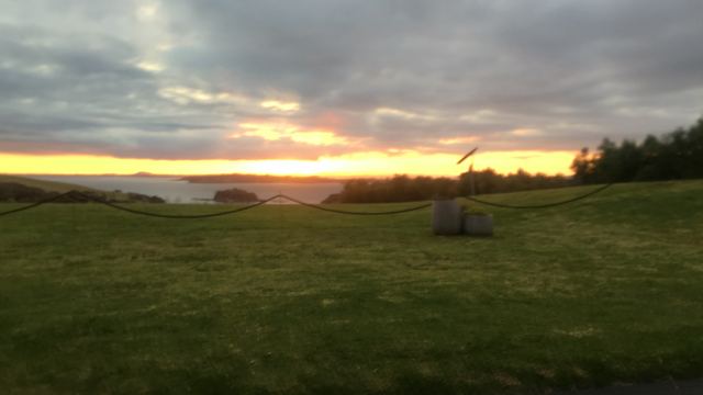 Sunset over a grassy headland